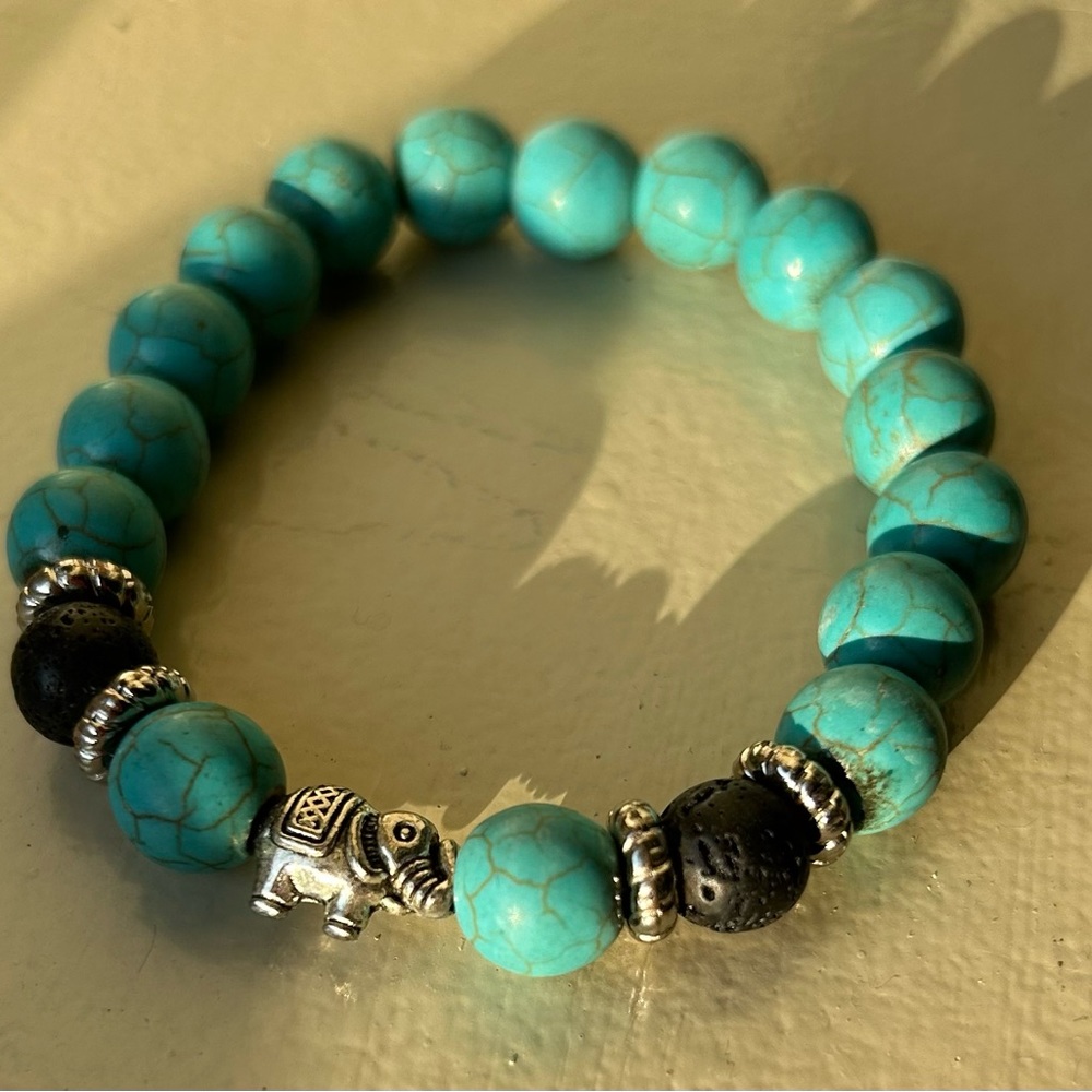 Ubud, Bali Turquoise and black lava stone bracelet with silver elephant charm